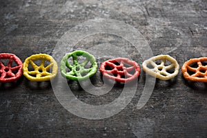 Indian crunchy fryums or papad snack in wheel, square and triangle shapewheel shape colourful fryums papad snack. selective focus