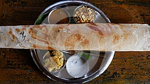 Indian cuisine large masala dosa and souses