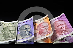 Indian currency. 100, 200, 500, and 2000 rupee note. Indian currency isolated on black background.