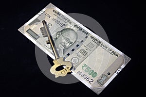 Indian currency. 500 rupee note with key. Indian currency isolated on black background.