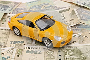 Indian currency notes and toy car in the hands bank loan concept