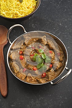 Indian Curry Pork Vindaloo in a Balti Dish with Lemon Rice