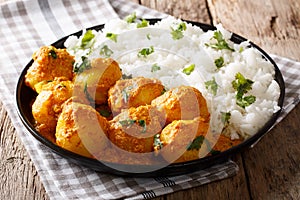 Indian curry potatoes Dum aloo in sauce with rice close-up. horizontal