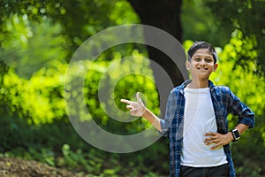 Indian cute child showing direction with hand