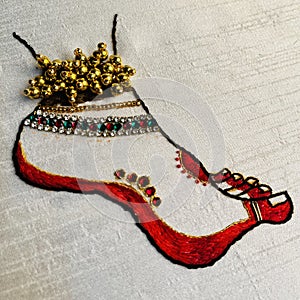 Indian dancer leg embroidery on a white cloth