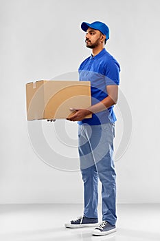 Indian delivery man with parcel box in blue