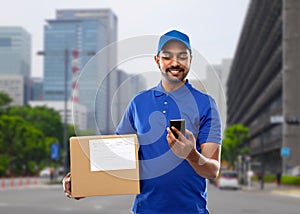 Indian delivery man with smartphone and parcel box