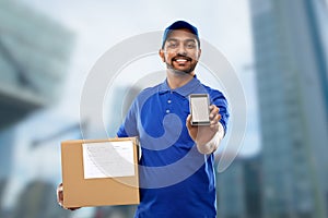 Indian delivery man with smartphone and parcel box