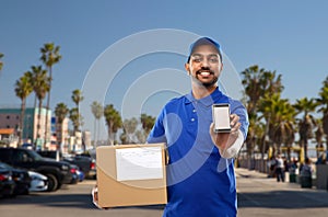 Indian delivery man with smartphone and parcel box