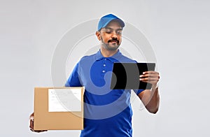 Indian delivery man with tablet pc and parcel box