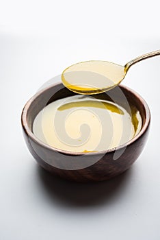 Indian or desi ghee or pure ghee served in a wooden bowl photo