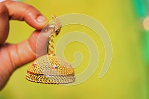 Indian design gold bangle  in red backdrop