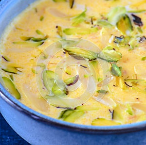 Indian dessert- kesar pista basundi in blue porrwey photo