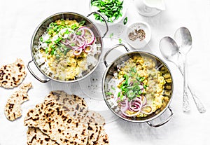 Indian dhal with jasmine rice, marinated red onion, scallion and whole grain flatbread on light background, top view. Flat lay, ve