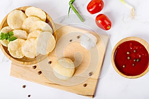 Indian dish luchi on a white table