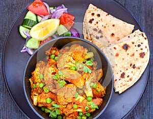Indian meal- Gobhi aloo with roti and salad photo