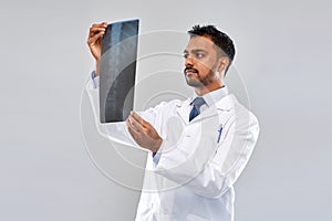 Indian doctor looking at spine x-ray