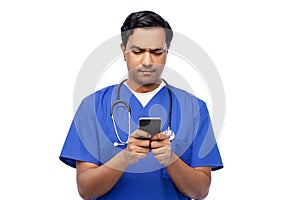 indian doctor or male nurse using smartphone