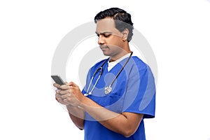 indian doctor or male nurse using smartphone