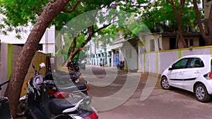 Indian empty street motorbikes and cars parking outside, pan house exterior shot