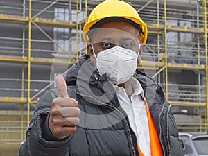 Indian engineer with ffp2 mask gesturing thumbs up