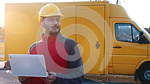 Indian Engineer Wearing Safety Helmet Holding A Laptop Checking His Planned Work