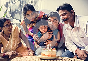 Indian family celebrating a birthday party photo