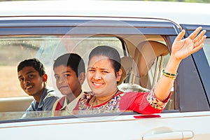 Indian family driving boys to school In front of house gates