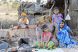 Indian family outdoors in desert on time Pushkar Camel Mela, Rajasthan, India