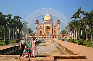 Indian family standing in front of Tomb of Safdarjung in New Del