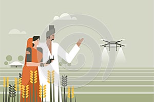 An Indian farmer along with his wife using a drone in the agricultural field