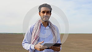 Indian farmer is checking soil quality before sowing. Agriculture, gardening or ecology concept