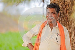 Indian farmer at green corn field