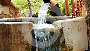 Indian farmland being irrigated by a tube well giving out water with an enormous flow, shot of a diesel water pump helping Indian