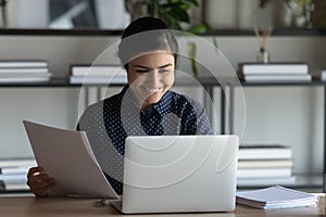 Indian female employee use pc accomplish paperwork feels satisfied