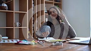 Indian female fashion designer working in her office, drawing sketches