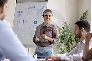 Indian female speaker present business project on whiteboard