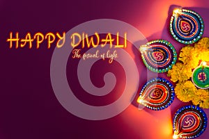 Indian festival Diwali, Diya oil lamps lit on colorful rangoli. Hindu traditional. Happy Deepavali. Copy space for text