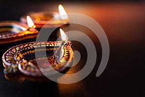 Indian festival Diwali, Diya oil lamps lit on colorful rangoli. Hindu traditional. Happy Deepavali. Copy space for text