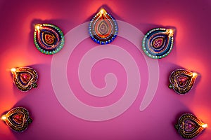 Indian festival Diwali, Diya oil lamps lit on colorful rangoli. Hindu traditional. Happy Deepavali. Copy space for text