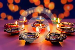Indian festival Diwali, Diya oil lamps lit on colorful rangoli. Hindu traditional. Happy Deepavali. Copy space for text
