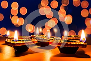 Indian festival Diwali, Diya oil lamps lit on colorful rangoli. Hindu traditional. Happy Deepavali. Copy space for text