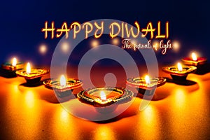 Indian festival Diwali, Diya oil lamps lit on colorful rangoli. Hindu traditional. Happy Deepavali. Copy space for text