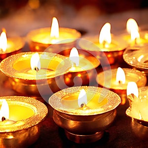 Indian festival Diwali, Diya oil lamps lit on colorful rangoli. Hindu traditional. Selective focus