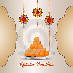 Indian festival of happy raksha bandhan celebration greeting card with crystal rakhi and sweet