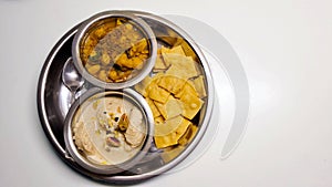 Indian festival platter with sweets and snacks on white background