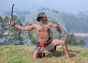 Indian fighter performing Kalaripayattu marital art demonstration in Kerala, India