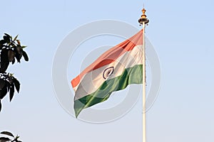 Indian flag flying against blue sky background. The National Flag of India is a horizontal rectangular tricolor saffron, white