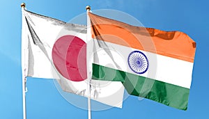 Indian flag and Japanese flag on cloudy sky.
