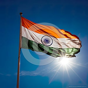 Indian flag, unfurled in all its glory on a sunny day against the clear blue sky.